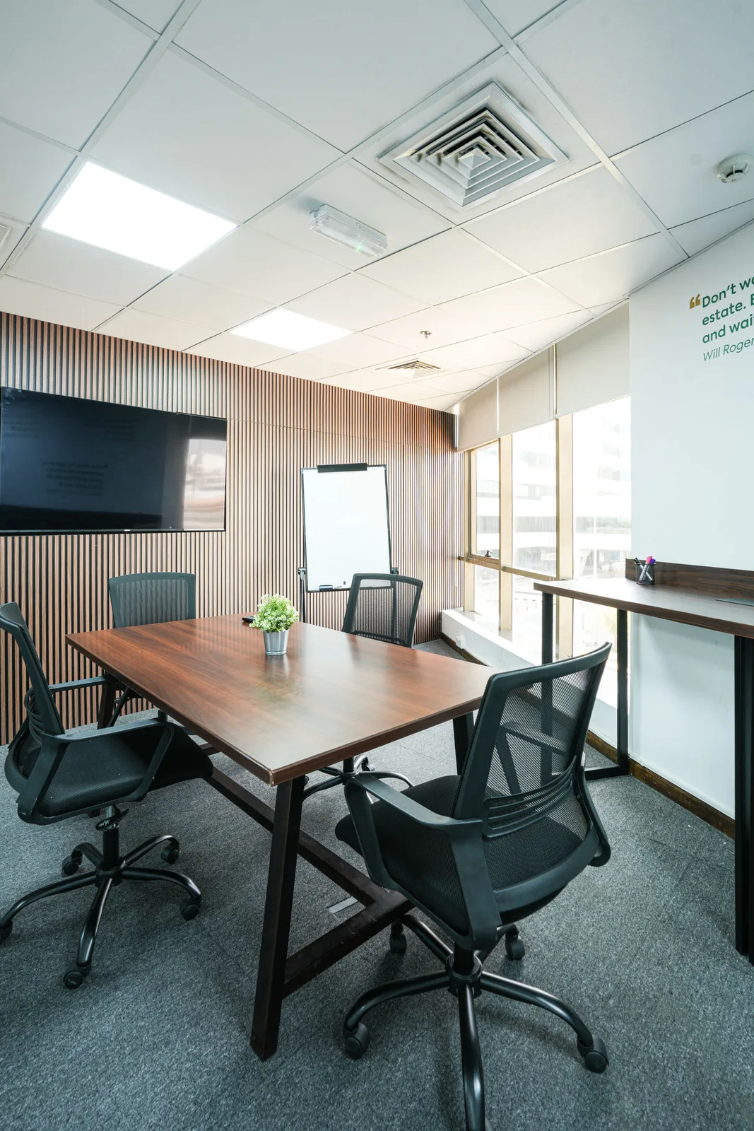 Wood-panel meeting room with TV and whiteboard at GAL Business Center Dubai